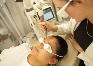 Clinician performing Fotona laser treatment for skin tightening in Melbourne cosmetic clinic