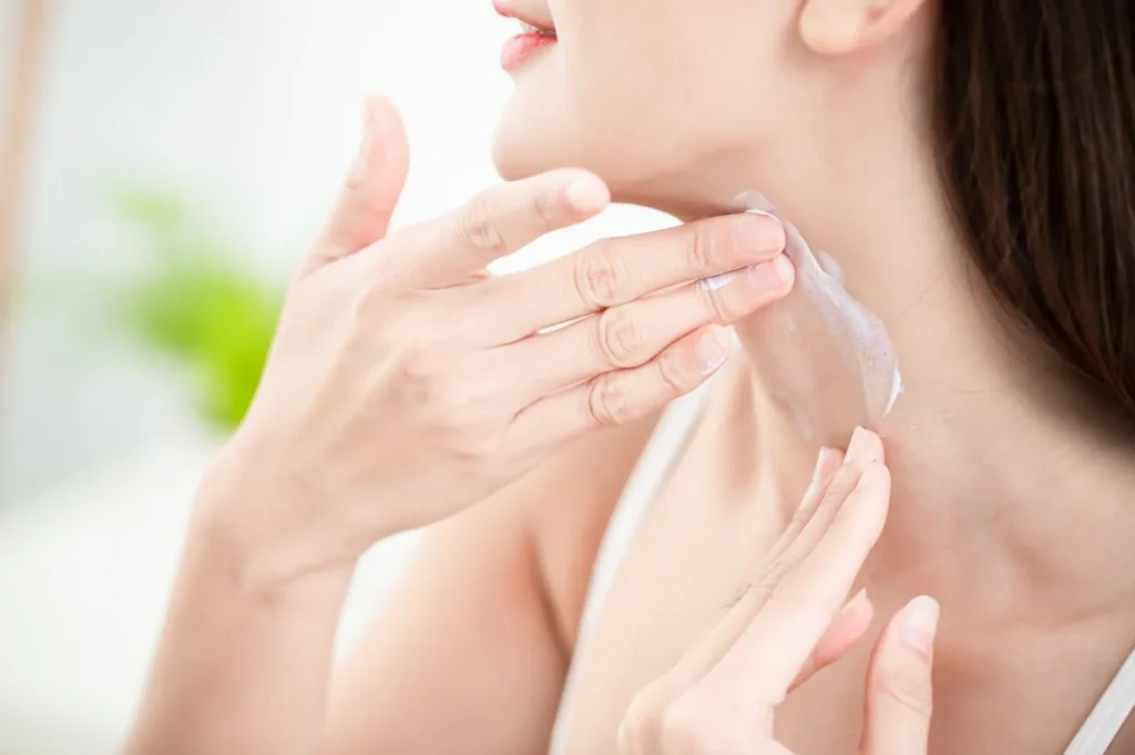 Applying skincare product to neck to help prevent fine lines and neck wrinkles