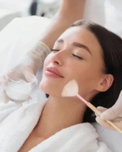 Chemical peel being brushed onto a woman's cheek in Melbourne