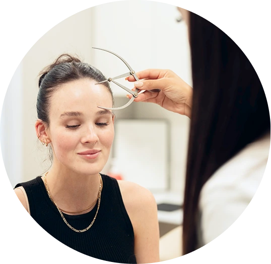 Clinician measuring facial proportions during consultation at a cosmetic clinic in Melbourne
