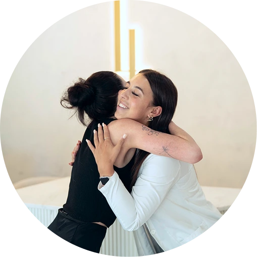 Client hugging clinician after treatment at a cosmetic clinic in Melbourne