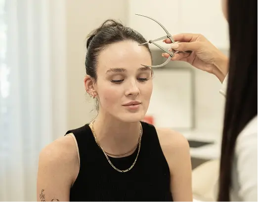 Clinician measuring facial structure before aesthetic treatment in Melbourne
