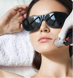 Close-up of a patient receiving a PicoSure Toning laser treatment at Luxe Lips to target sun damage and uneven skin tone, showing the precise application of the picosecond laser handpiece.