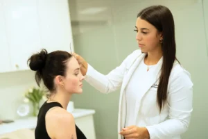 Cosmetic practitioner assessing a patient&rsquo;s facial structure during consultation, explaining what is regenerative medicine and personalised aesthetic treatment options for skin rejuvenation