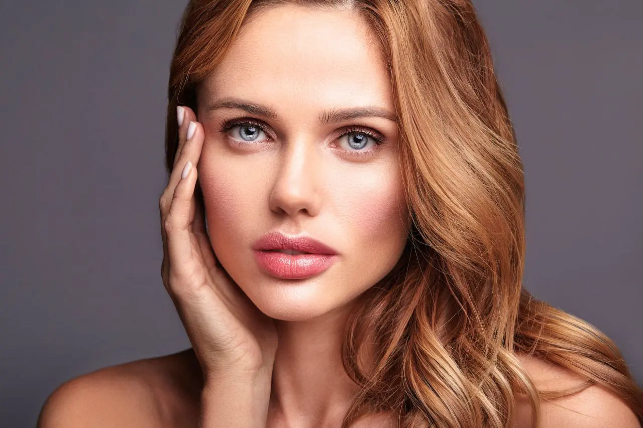 Close-up of a woman's face highlighting smooth, full lips, lip treatment guide by Luxe Lips