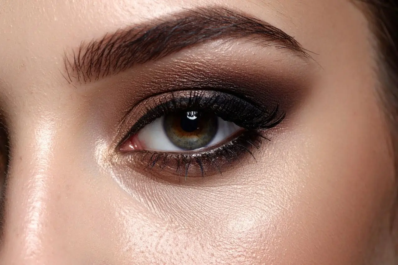 Close-up of a woman's eye area showing smooth skin around the eye and a defined brow
