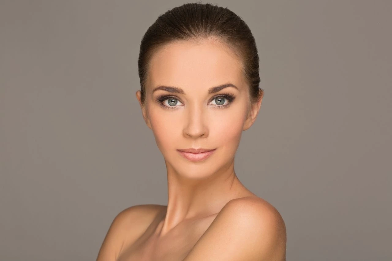 A woman with glowing skin representing skin needling with exosomes