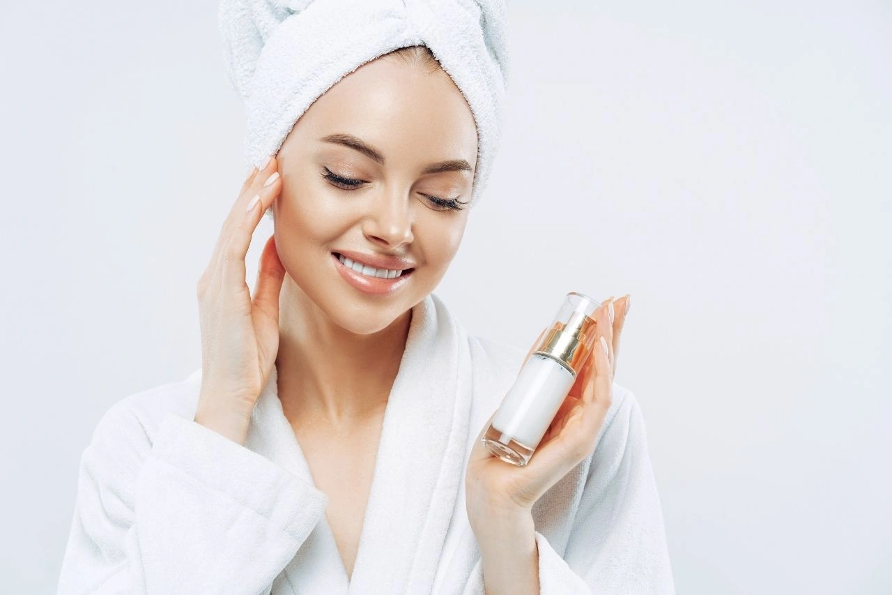 A woman with a skincare product containing exosomes