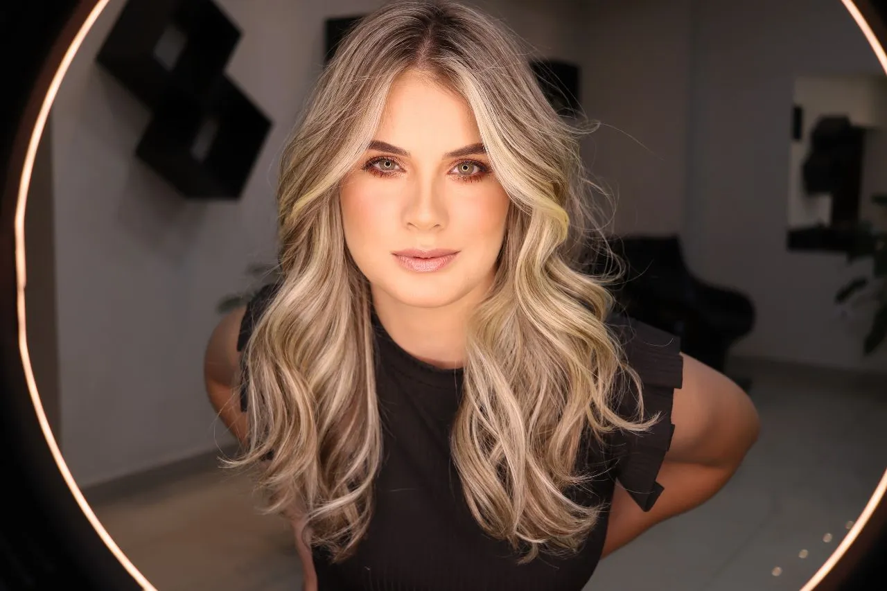 Woman with clear, even-toned skin framed by a ring light, illustrating what Lumecca IPL does for the skin