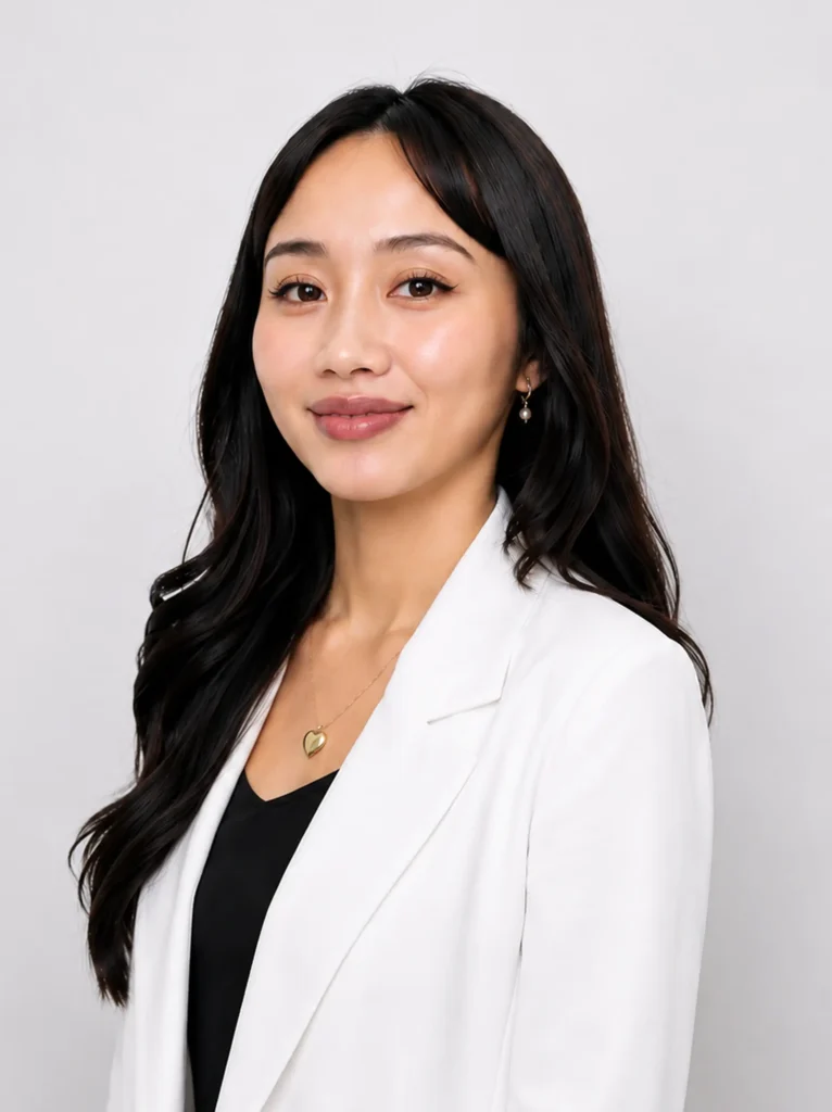 Nurse Beariz Diopido of Luxe Lips, smiling, in a white blazer